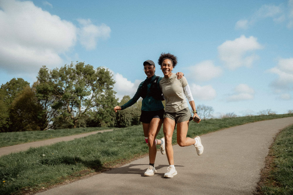 Two runners from our Your Pace or Mine run club, running down Primrose Hill.